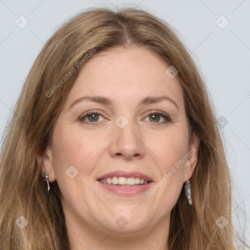 Joyful white adult female with long  brown hair and grey eyes