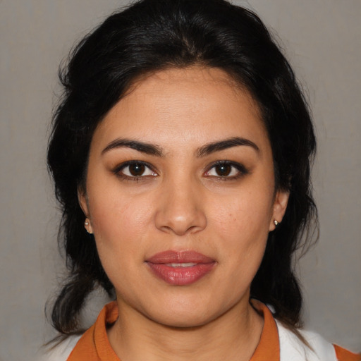 Joyful latino young-adult female with medium  brown hair and brown eyes