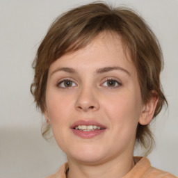 Joyful white young-adult female with medium  brown hair and grey eyes