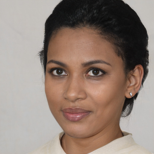 Joyful latino young-adult female with short  black hair and brown eyes