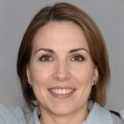 Joyful white adult female with medium  brown hair and brown eyes