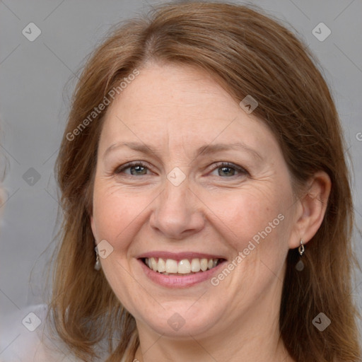 Joyful white adult female with long  brown hair and brown eyes