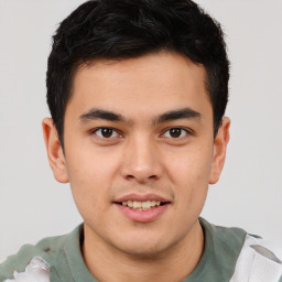 Joyful latino young-adult male with short  brown hair and brown eyes