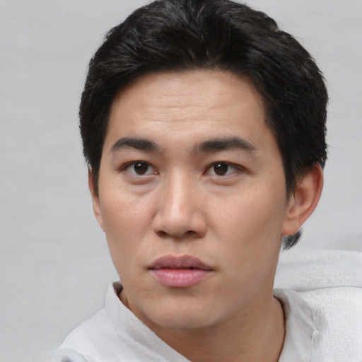 Neutral white young-adult male with short  black hair and brown eyes