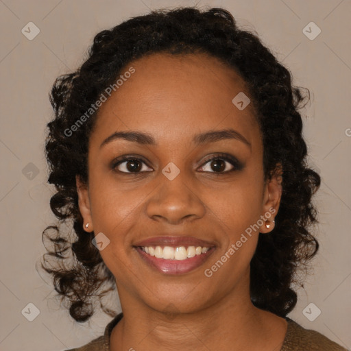 Joyful black young-adult female with long  brown hair and brown eyes