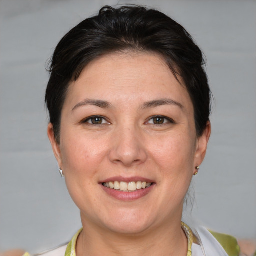 Joyful white adult female with short  brown hair and brown eyes