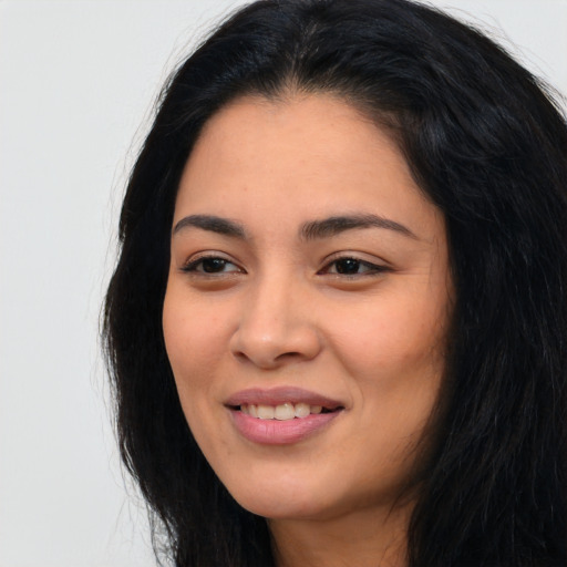 Joyful asian young-adult female with long  black hair and brown eyes
