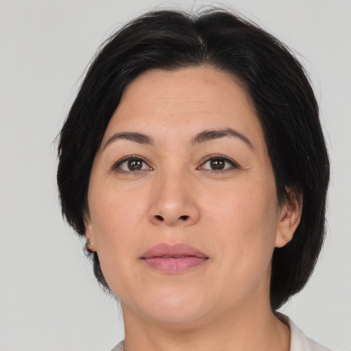 Joyful asian adult female with medium  brown hair and brown eyes