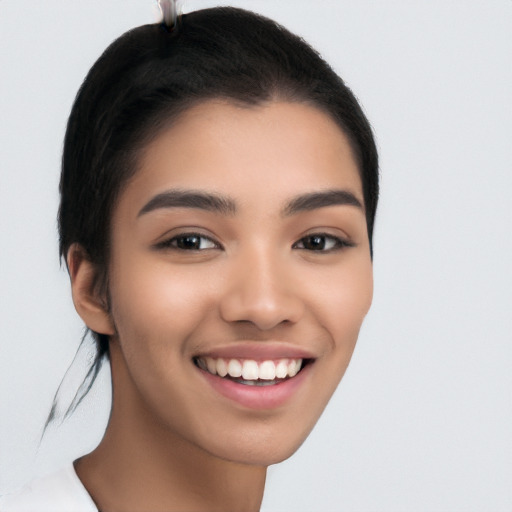 Joyful latino young-adult female with long  brown hair and brown eyes