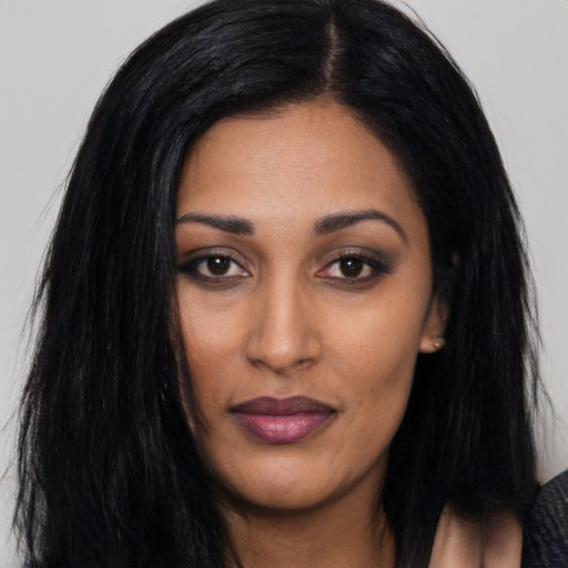 Joyful asian young-adult female with long  black hair and brown eyes