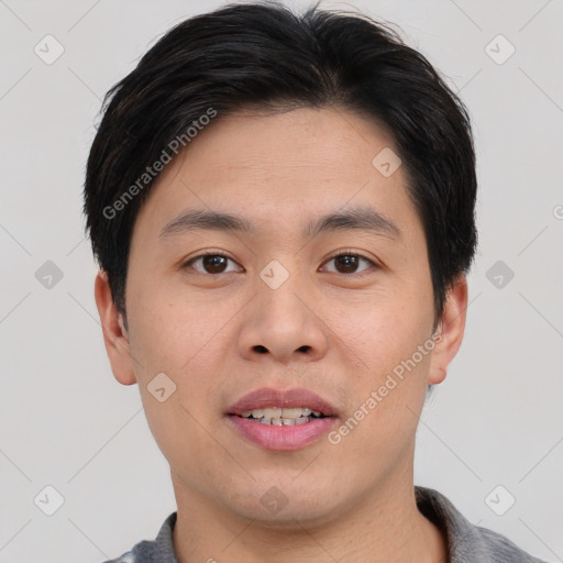 Joyful asian young-adult male with short  black hair and brown eyes