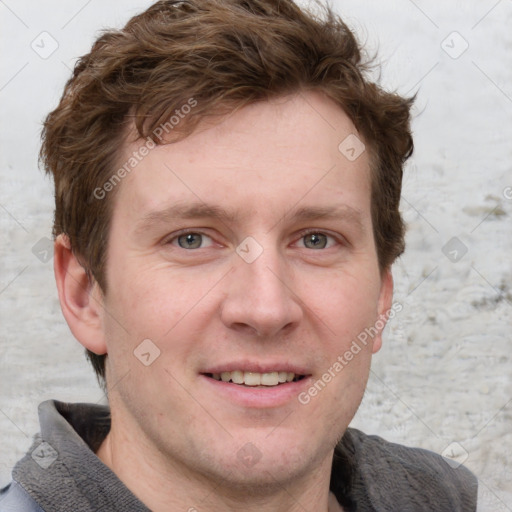 Joyful white adult male with short  brown hair and grey eyes