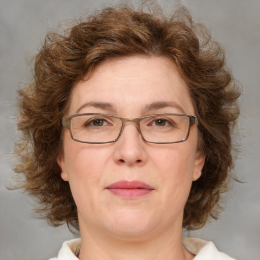 Joyful white adult female with medium  brown hair and green eyes