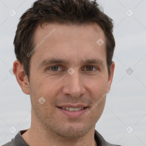 Joyful white adult male with short  brown hair and grey eyes