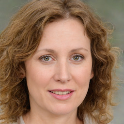 Joyful white young-adult female with medium  brown hair and green eyes