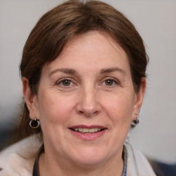 Joyful white adult female with medium  brown hair and brown eyes