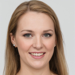 Joyful white young-adult female with long  brown hair and green eyes