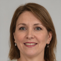 Joyful white adult female with medium  brown hair and grey eyes