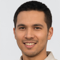 Joyful latino young-adult male with short  brown hair and brown eyes