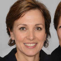 Joyful white adult female with medium  brown hair and brown eyes