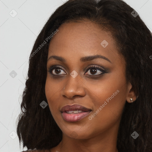 Joyful black young-adult female with long  black hair and brown eyes