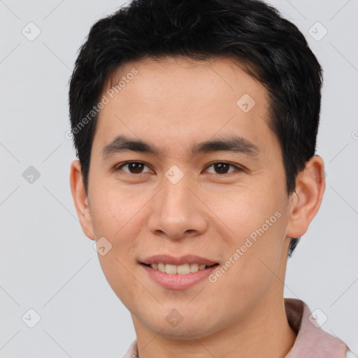 Joyful asian young-adult male with short  brown hair and brown eyes