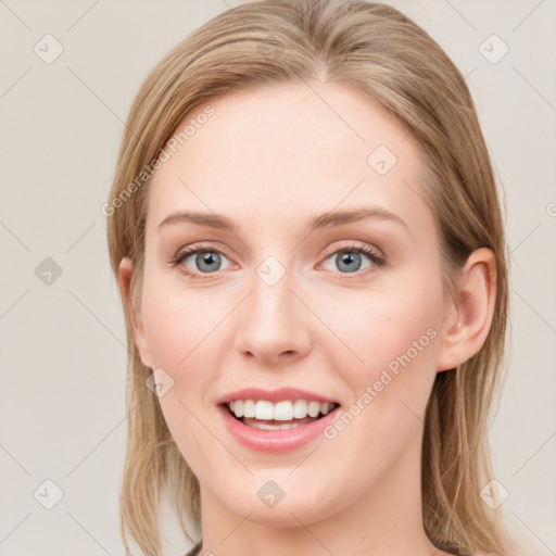 Joyful white young-adult female with long  brown hair and blue eyes