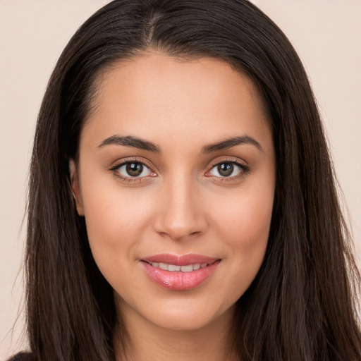 Joyful white young-adult female with long  brown hair and brown eyes