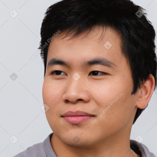 Joyful asian young-adult male with short  black hair and brown eyes