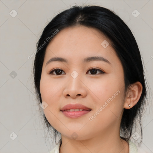 Joyful asian young-adult female with medium  black hair and brown eyes