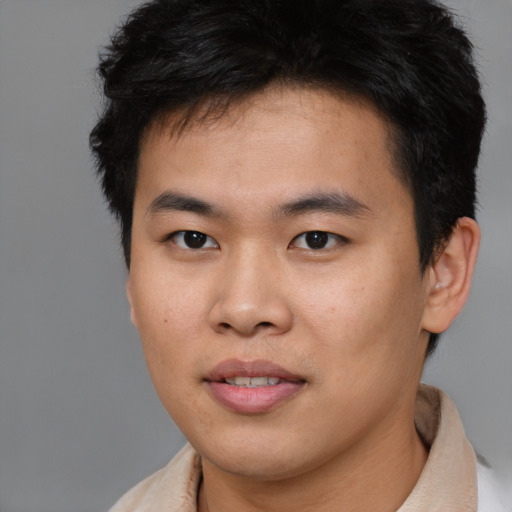Joyful asian young-adult male with short  brown hair and brown eyes