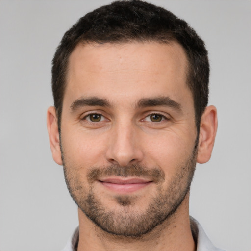 Joyful white young-adult male with short  brown hair and brown eyes