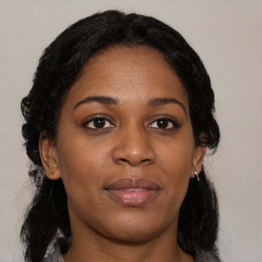 Joyful black young-adult female with medium  black hair and brown eyes