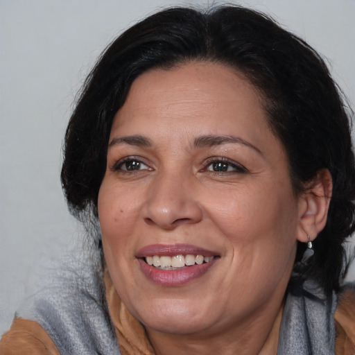 Joyful black adult female with medium  brown hair and brown eyes