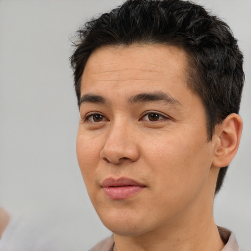 Joyful asian young-adult male with short  black hair and brown eyes