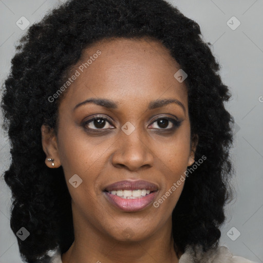 Joyful black young-adult female with long  brown hair and brown eyes