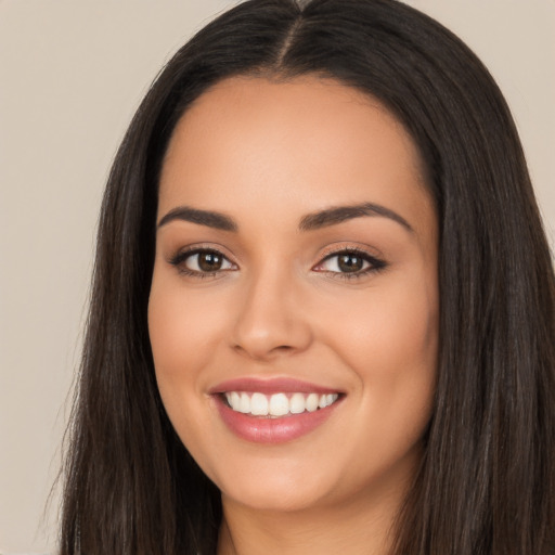 Joyful latino young-adult female with long  black hair and brown eyes