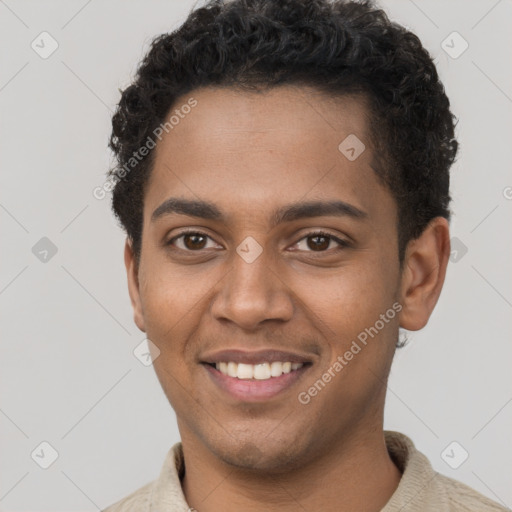 Joyful black young-adult male with short  brown hair and brown eyes