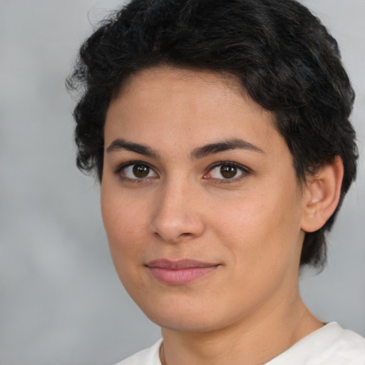 Joyful latino young-adult female with short  brown hair and brown eyes