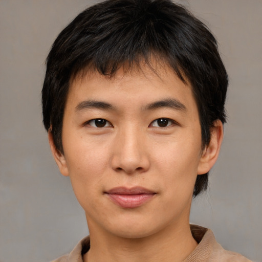 Joyful asian young-adult male with short  brown hair and brown eyes
