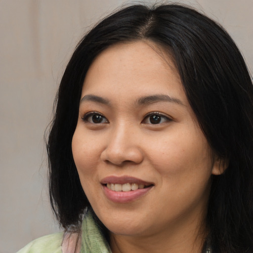 Joyful asian young-adult female with long  black hair and brown eyes