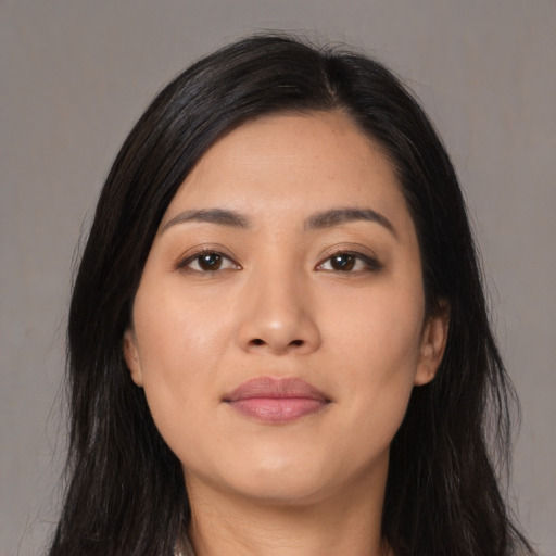 Joyful latino young-adult female with long  black hair and brown eyes