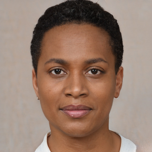 Joyful black young-adult female with short  black hair and brown eyes