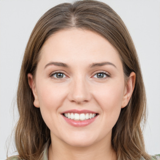 Joyful white young-adult female with long  brown hair and grey eyes