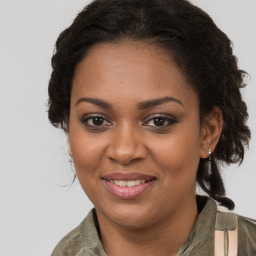 Joyful black young-adult female with long  brown hair and brown eyes