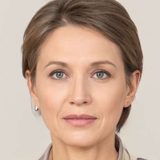 Joyful white adult female with medium  brown hair and grey eyes