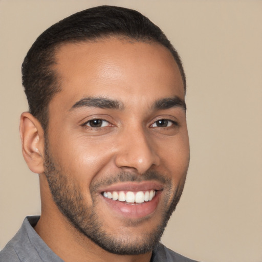 Joyful latino young-adult male with short  black hair and brown eyes