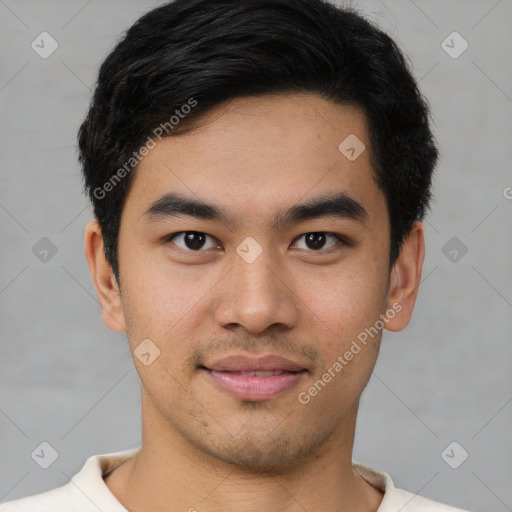 Joyful asian young-adult male with short  brown hair and brown eyes