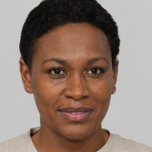 Joyful black adult female with short  brown hair and brown eyes