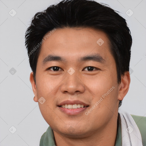 Joyful asian young-adult male with short  black hair and brown eyes